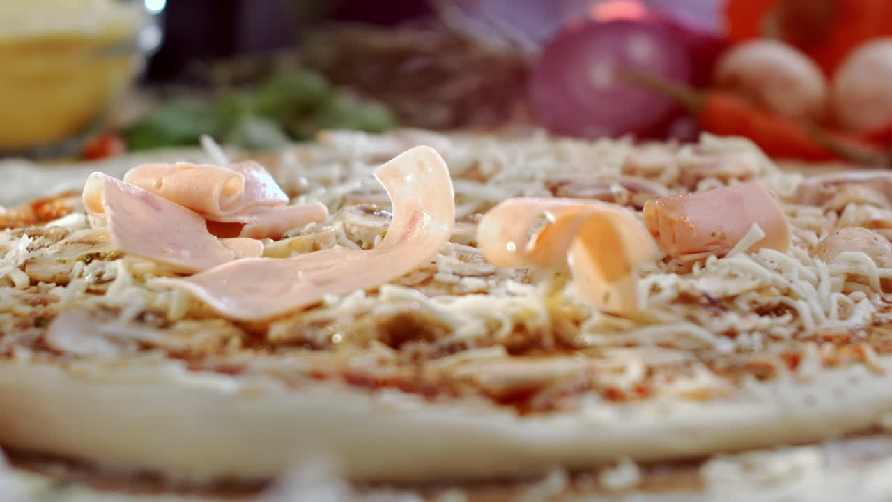 Making pizza with ham and cheese