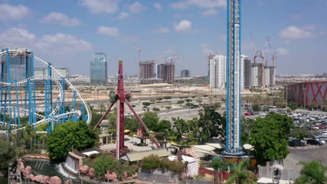 amusement park with roller coaster and city views