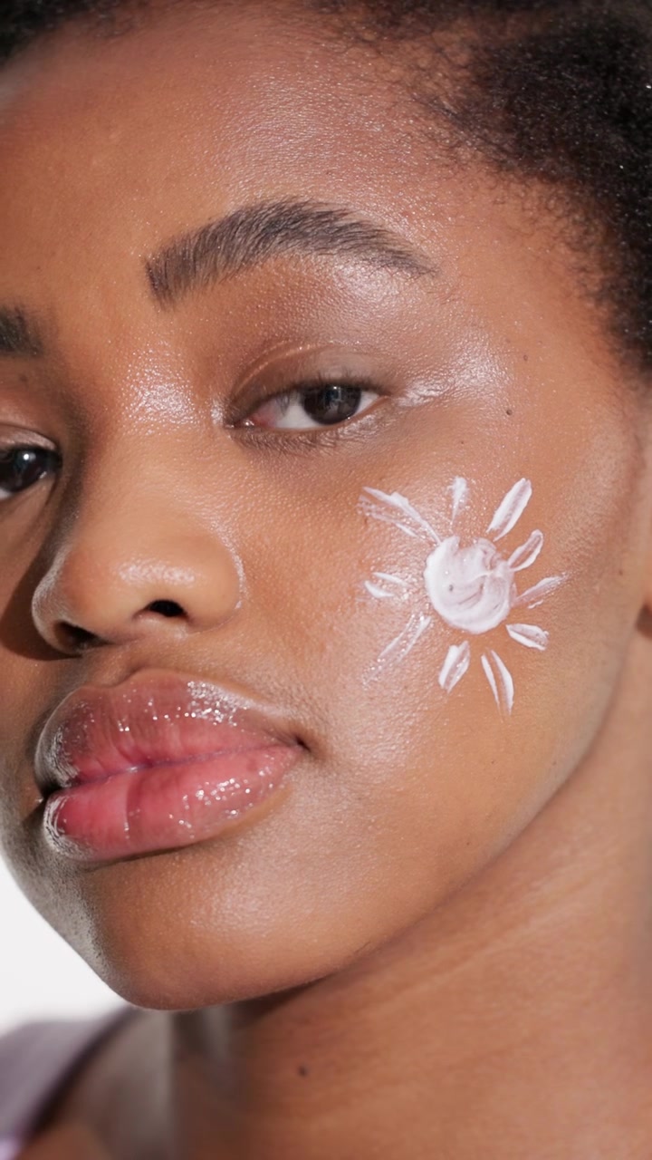 Young Woman with Sunscreen Drawn on Cheek
