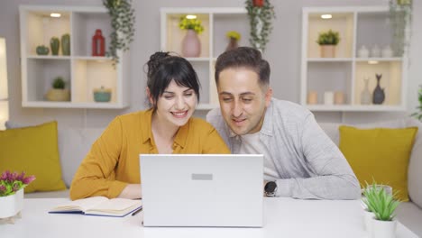 couple video chatting on laptop.