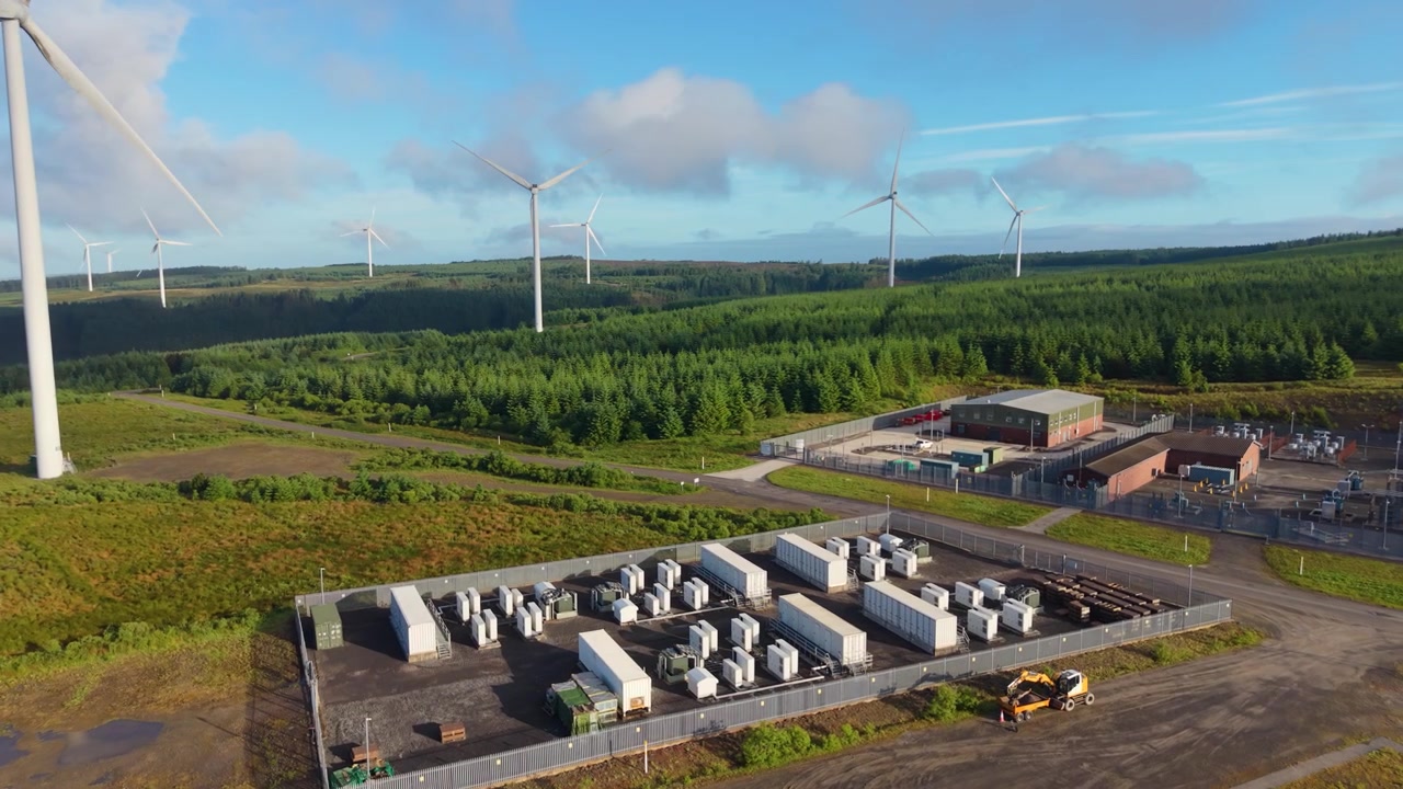 BESS Battery Energy System Storage Facility at Wind Energy Farm Infrastructure in Wales, UK. Perfect for concepts on green technology, sustainability, and the future of power. 4K.
