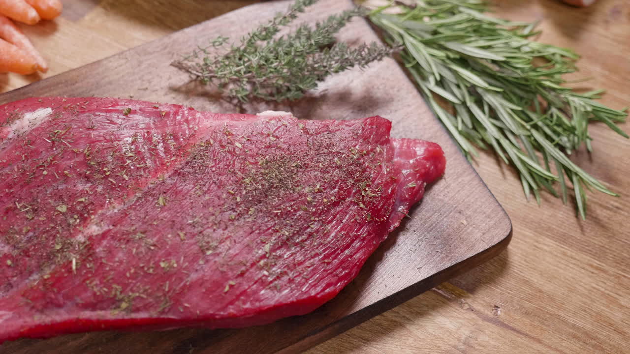 Preparing raw beef with herbs