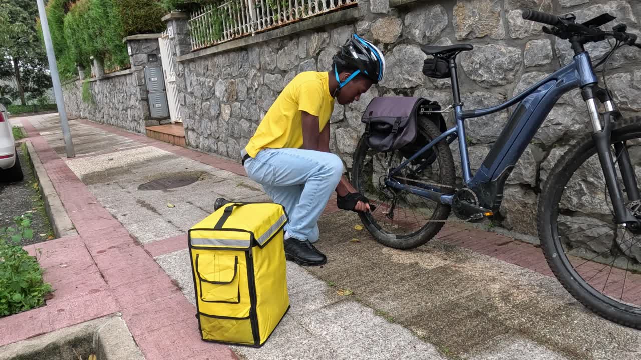 Delivery worker repairing bike tire