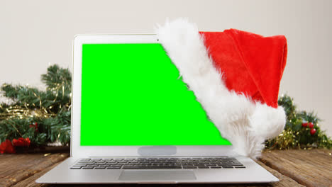 Laptop-with-santa-hat-on-a-plank