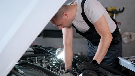 professional mechanic working on a car engine in a garage
