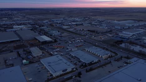 night drone shot of parked semi-trucks at a gas station
