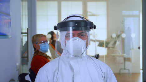 close up of tired doctor in stomatological office looking on camera