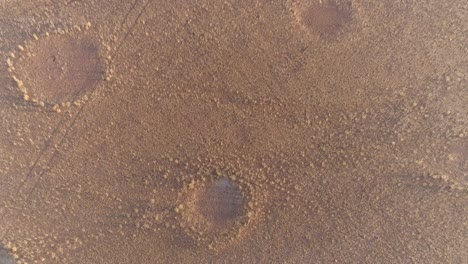 4k circular zoom out aerial view of the famous fairy circles in the namib desert,namibia
