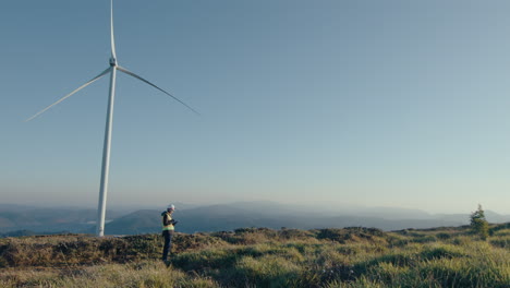 female engineer standing at wind farm