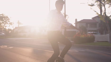 A person riding a unicycle on a sunny street