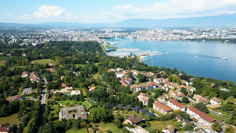 reveal drone shot of water fountain of geneva during the day (rade of geneva) from cologny, switzerland