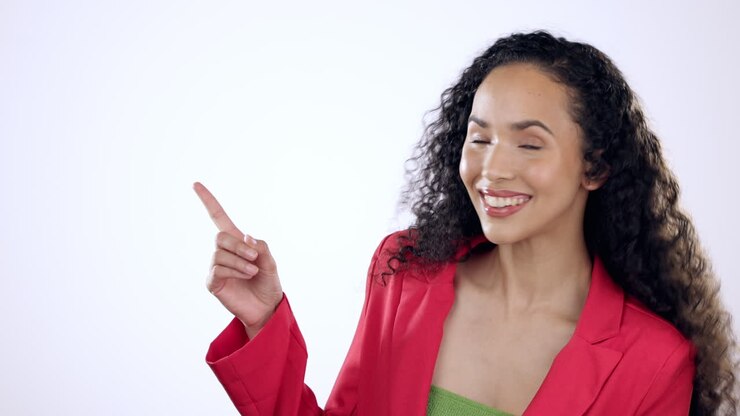 Hand pointing, smile and woman face in studio