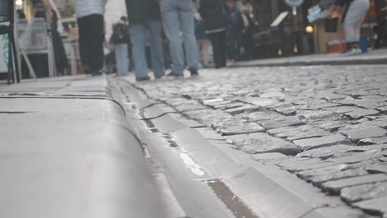 City Street with Cobblestone Pavement and People Walking