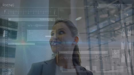 Animation-of-data-processing-on-screens-over-smiling-caucasian-businesswoman-in-modern-building