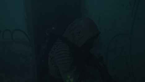 a wounded soldier in the abandoned military complex during the recon mission