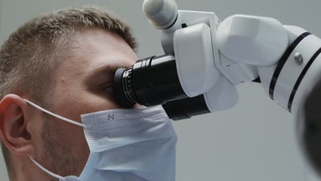 dentist using dental microscope