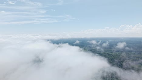 floating above puffy clouds on a sunny day, bright sky visible beyond the upper layer