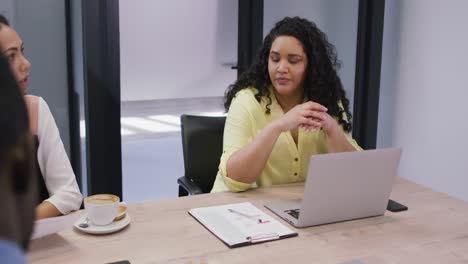 Diverse-group-of-business-people-working-together,-discussing-work-in-modern-office