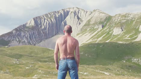 man contemplating a mountain view