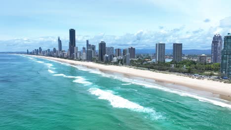 Birds-eye-view-of-the-iconic-high-rise-skyline-looking-out-over-crashing-waves