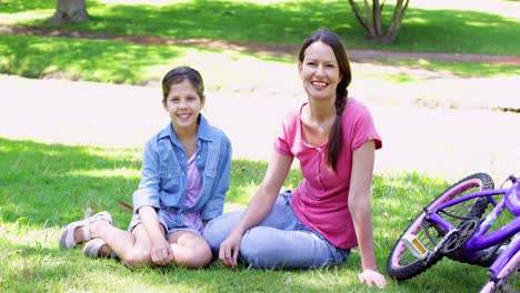 cute mother and daughter taking a break on their bike ride