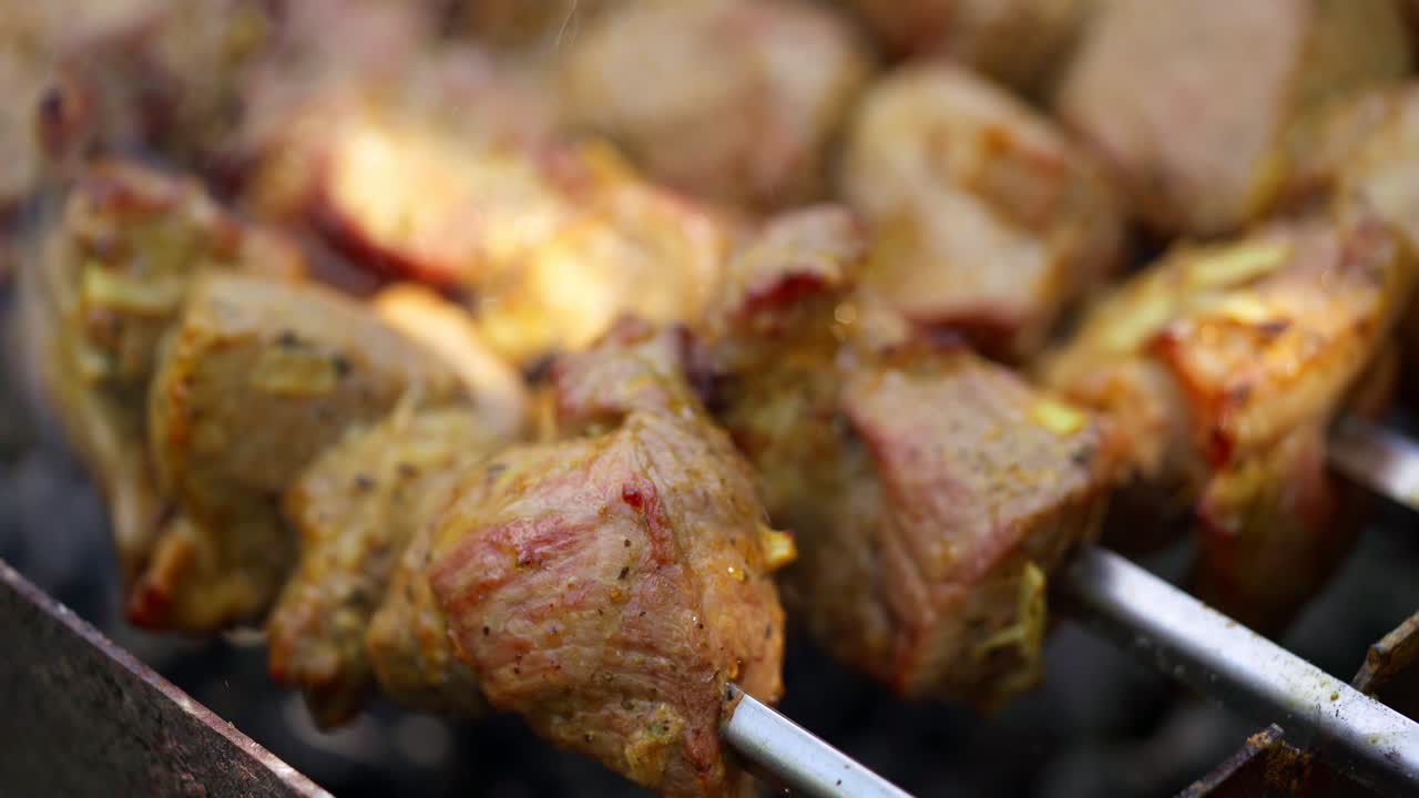 Barbecue cooking. Meat roasts on fire. Tasty pork on skewers on grill. Kebab. Delicious food. Close-up.