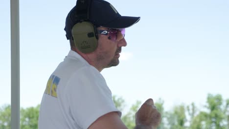 sportsman shoots from a double-barreled shotgun, a sports field for a shooting test is shooting at flying skeet