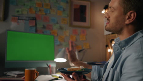 confident person gesturing mockup computer at home closeup. man eating talking