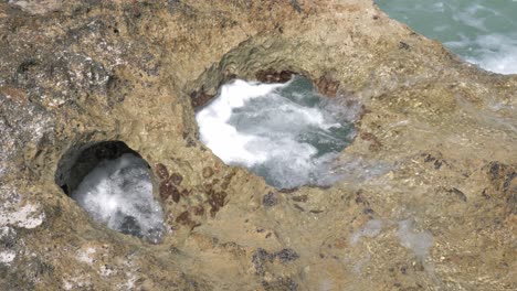 Waves-carving-a-hole-in-the-rocky-shore