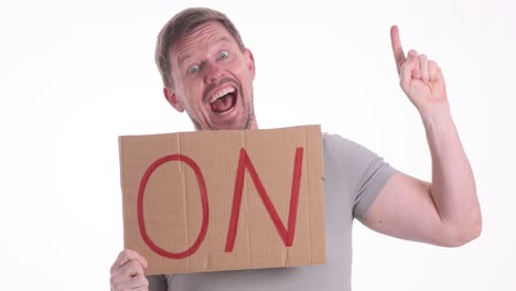 man holding a 'no' sign with a surprised expression and gesturing