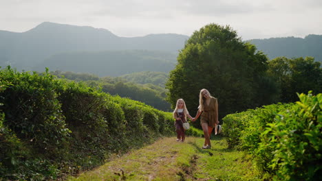 mother and daughter enjoying a walk in a tea plantation