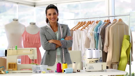 pretty fashion designer standing with arms crossed