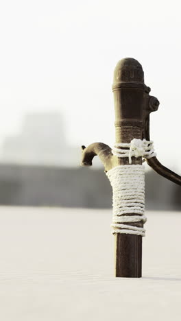rustic water pump stands alone in an expansive landscape at dusk