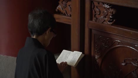 woman reading a book in a traditional temple