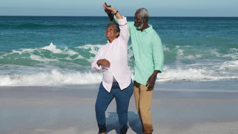 senior couple dancing at the beach