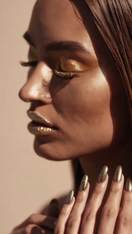 close-up beauty portrait with golden metallic makeup