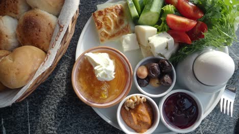 turkish breakfast spread with bread, cheese, olives, jam, and more