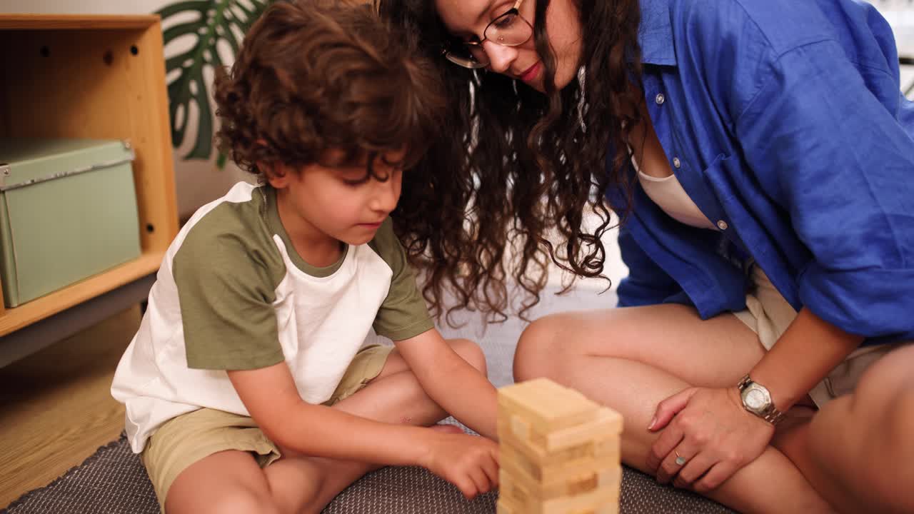 Mother and son playing jenga at home