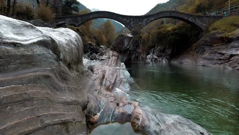 crystal clear water flows under the bridge in lavertezzo, verzasca valley