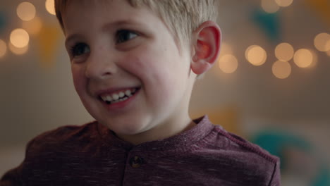 portrait-cute-little-boy-smiling-making-faces-looking-at-camera-happy-child-at-home-in-bedroom