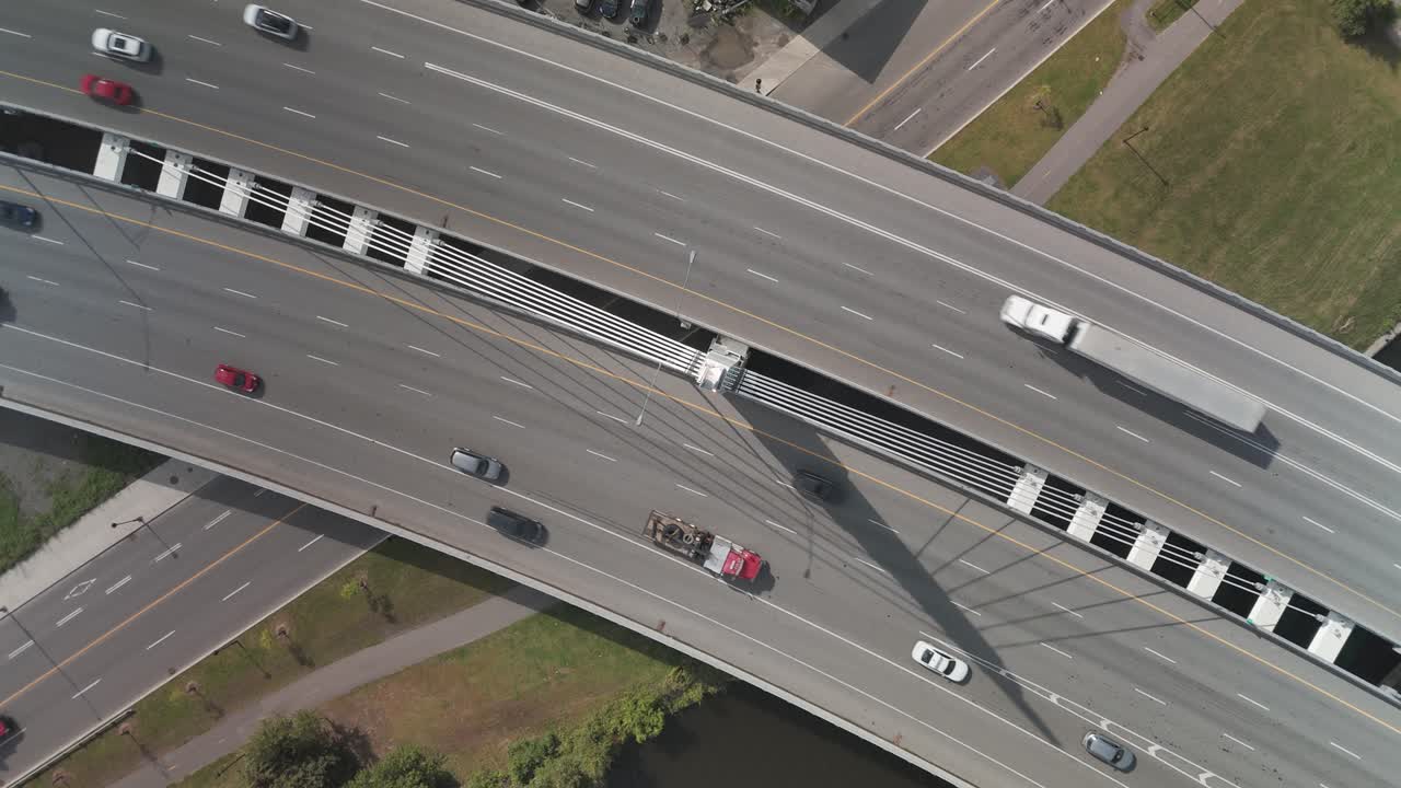 A drone shot of cars and trucks on Turcot interchange. Spinning movement from camera looking down.