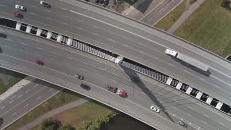 a drone shot of cars and trucks on turcot interchange. spinning movement from camera looking down.
