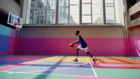 young man dribbling a basketball on a vibrant urban court