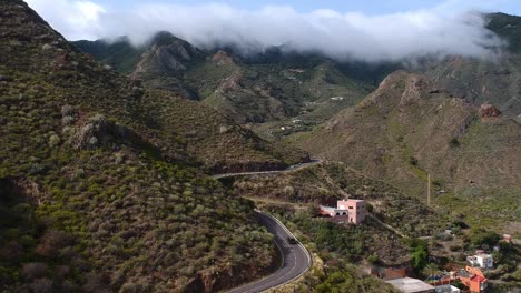 Winding-mountain-roads-and-majestic-valley-of-Tenerife-island,-aerial-descend-view