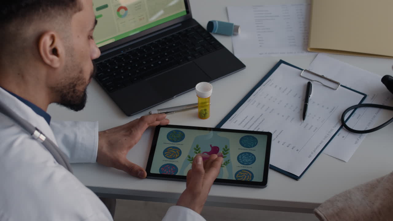 Doctor consulting with patient using tablet