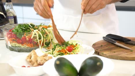 plating zucchini noodles on a plate adding to spiralizer to make zucchini noodles zoodles adding to bowl healthy vegan vegetarian lifestyle diet detox