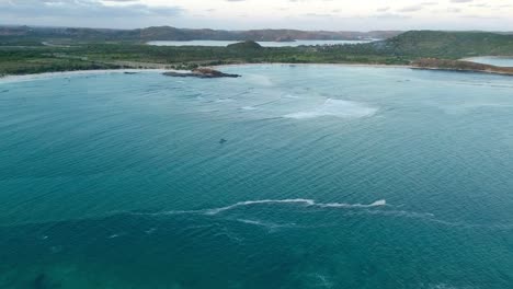 drone video of tanjung ann beach – aerial bay view with turquoise waters, white sand, and scenic reef on lombok’s stunning southern coastline