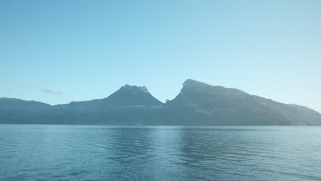 scenic lake view of overlooking mountains in faulensee switzerland into morning valley