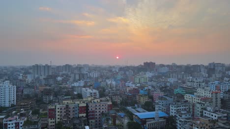 red an orange sunset cityscape of dhaka city urban area in bangladesh, asia