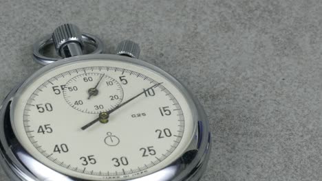 chronometer or sitopwatch on empty gray background for countdown and timing subjects